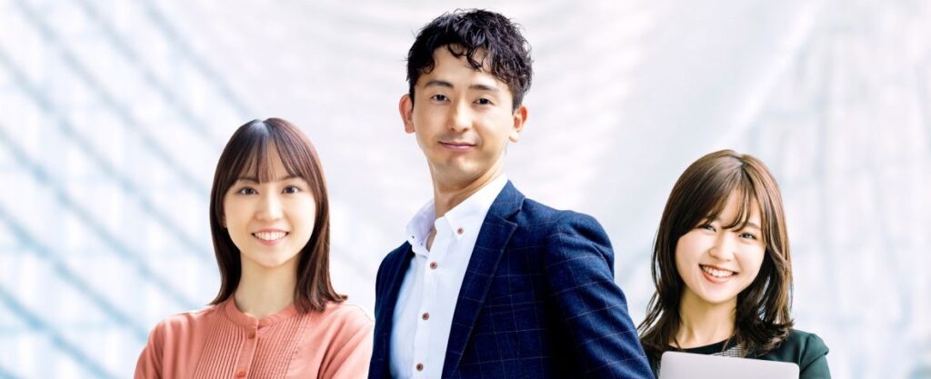 オフィスで笑顔の男女社員が並ぶ採用イメージ。若手社員が活躍する働きやすい職場環境を表現したビジネスチームの写真。